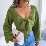 Green ribbed knit crop top with V-neck and front bow detail, long sleeves