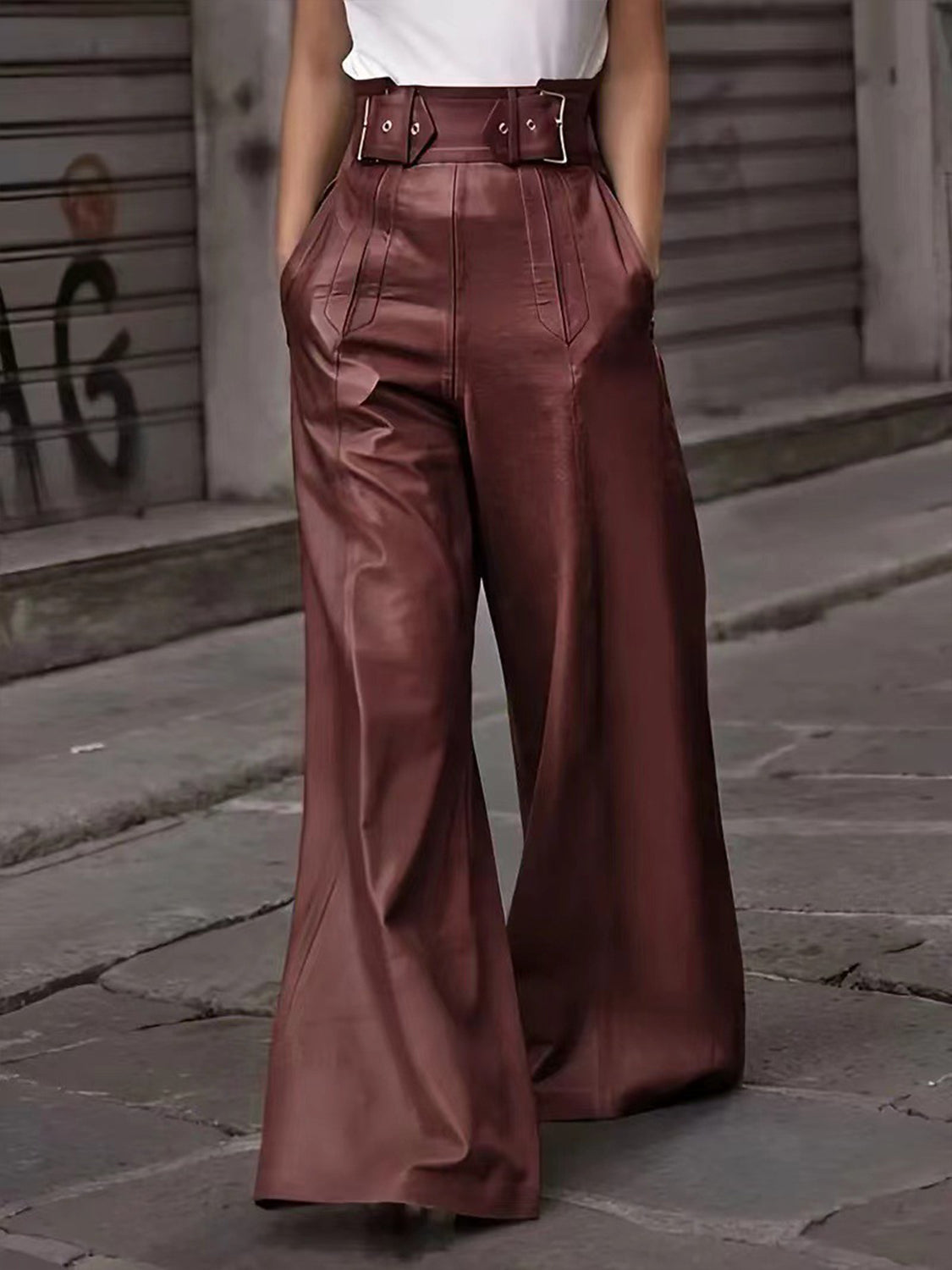 Burgundy faux leather palazzo trousers with belted waist and wide legs.