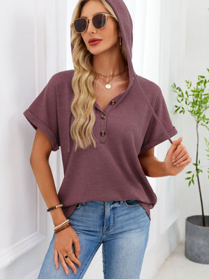 Waffle knit hooded top in brick red with short sleeves and button placket.