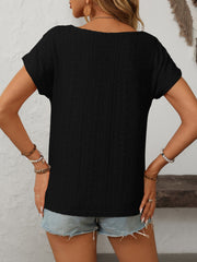 Black eyelet knit t-shirt with short sleeves and a scoop neckline.
