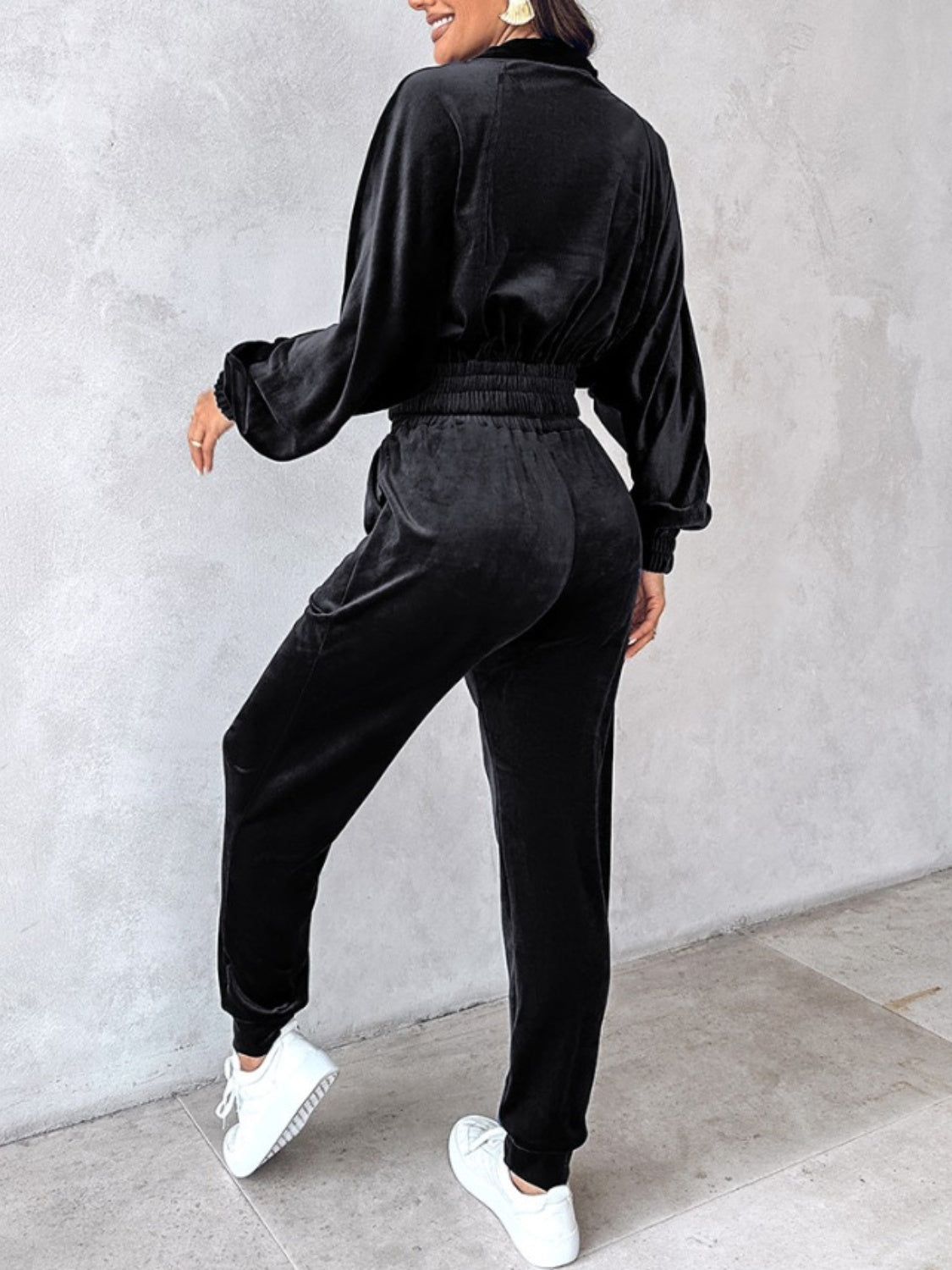 Black velvet crop tracksuit with zipper detail and elastic waistband.