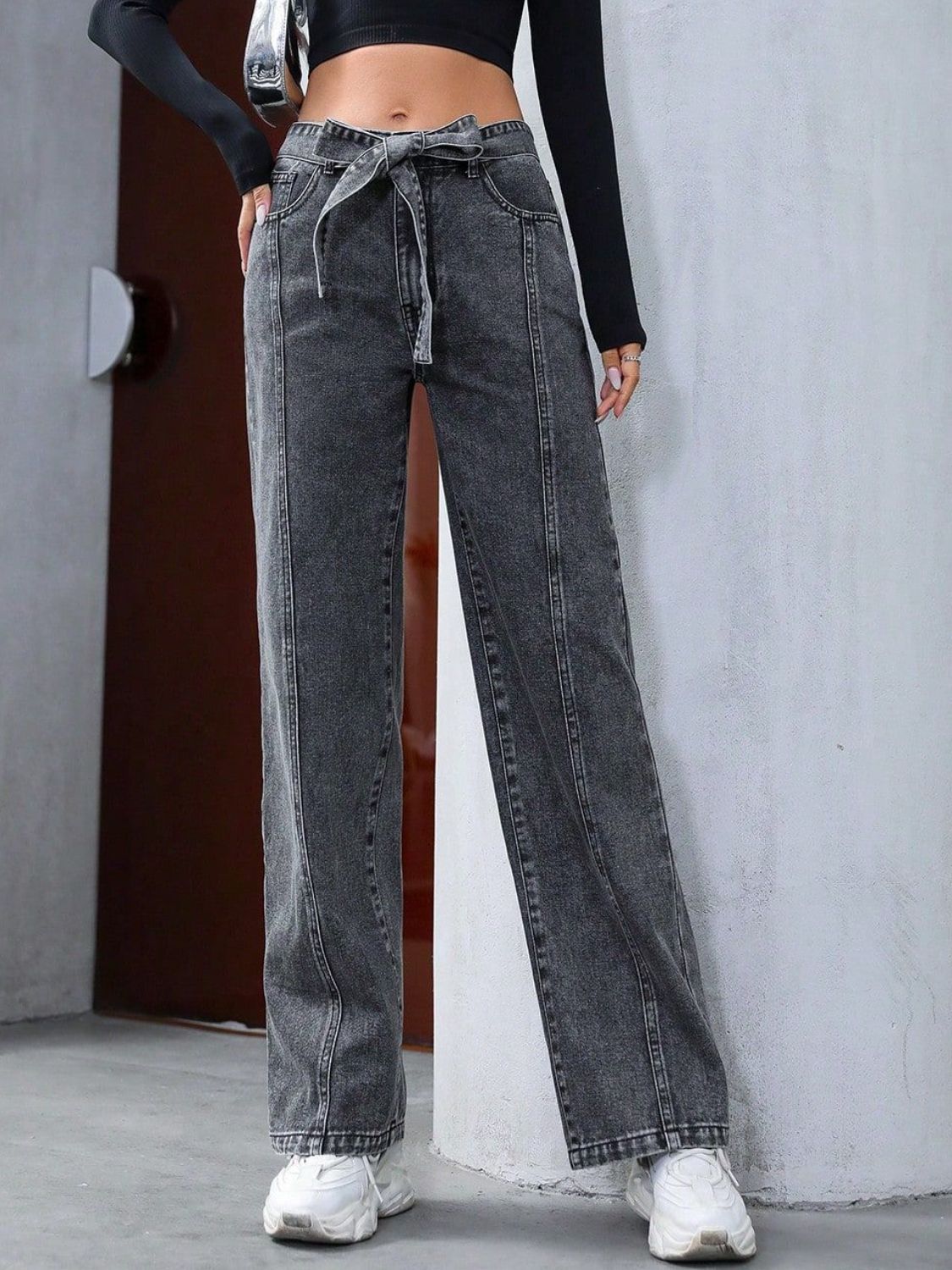 Belted wide-leg washed denim trousers in dark gray with a tie waist and seam detail.