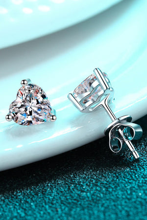 Silver heart-cut moissanite stud earrings with a classic prong setting.