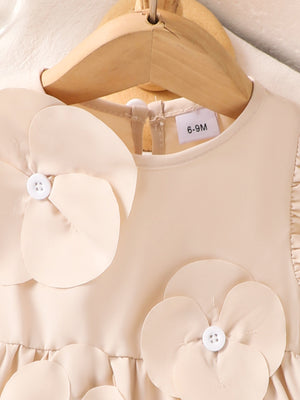 Off-white baby dress with flower appliqués and ruffle sleeves.