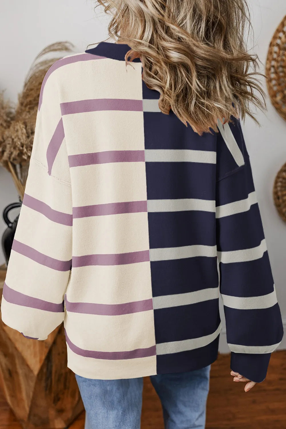 Colorblock stripe knit pullover with cream and navy panels.