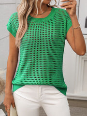 Green openwork knit crewneck top with short sleeves, styled with white pants.