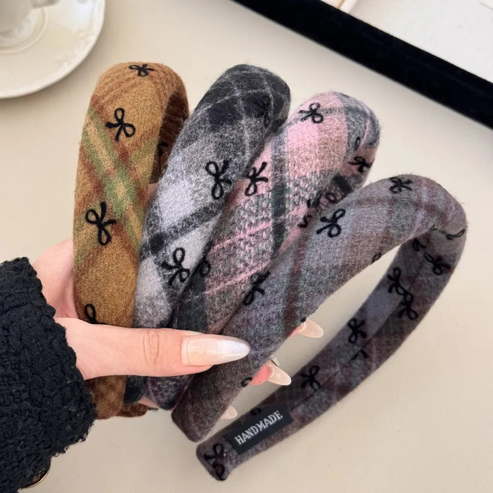Embroidered plaid padded headbands in blush pink, camel, and dark gray with bow detail.