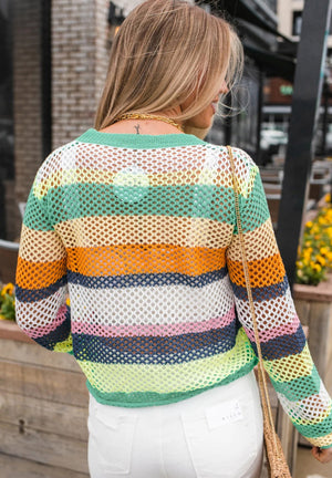 Rainbow crochet knit sweater with openwork stripes in green, yellow, orange, white, pink, and blue.