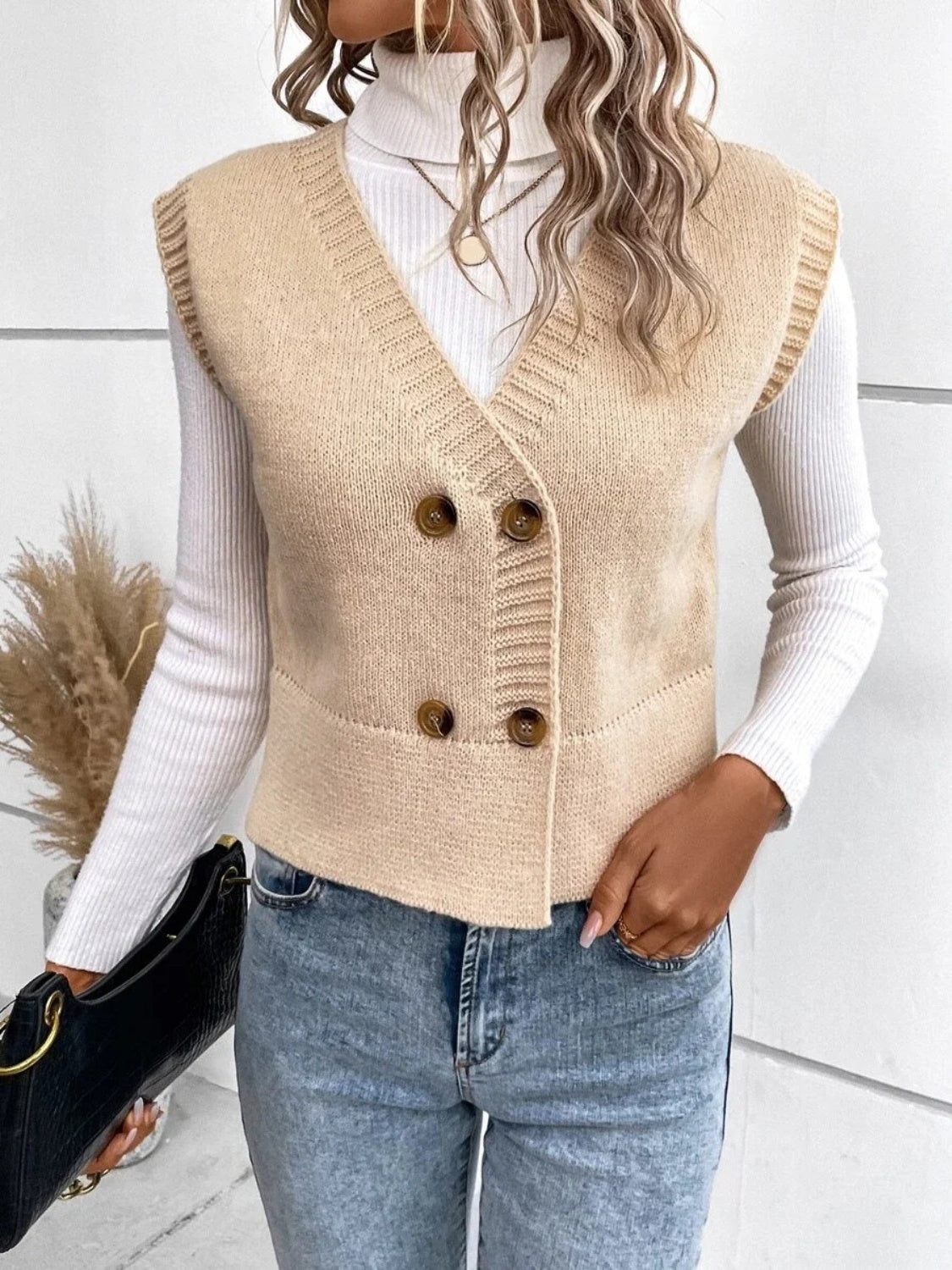 Tan knit vest with ribbed trim and double-breasted buttons, V-neck, sleeveless.