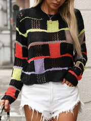 Black openwork knit sweater with colorful patchwork blocks and stripes.