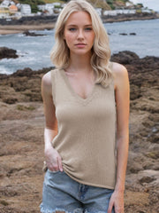 Khaki knit tank top with deep V-neck and tie straps, styled with denim shorts.