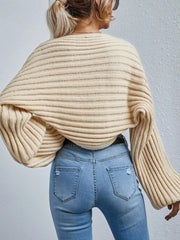 Beige ribbed knit cardigan with balloon sleeves and a cropped length.