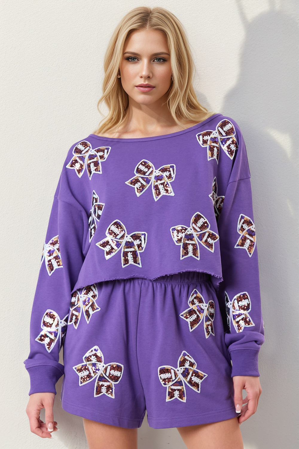 Purple cropped sweatshirt and shorts set with sequin bow embellishments