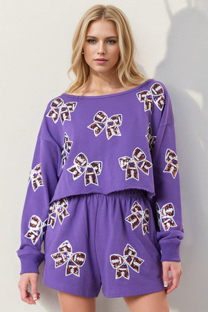 Purple cropped sweatshirt and shorts set with sequin bow embellishments