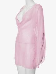 Pink sheer chiffon mini dress with draped neckline and long sleeves.