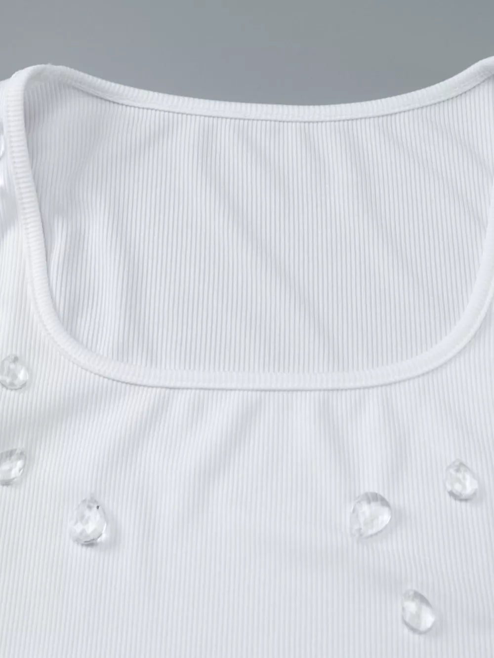 White ribbed square neck tank top with scattered rhinestone embellishments.