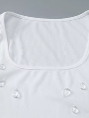 White ribbed square neck tank top with scattered rhinestone embellishments.
