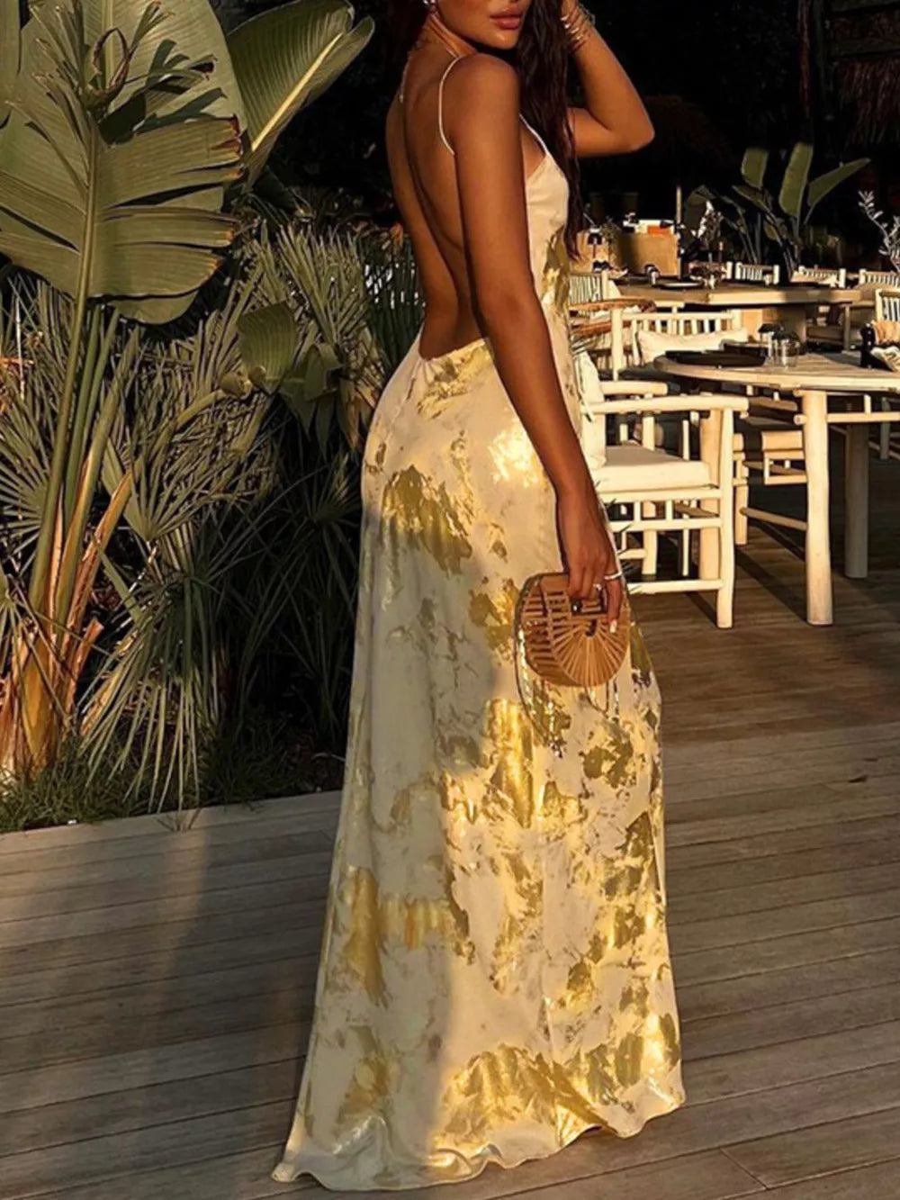 Cream maxi dress with abstract gold pattern, V-neck, and backless design.