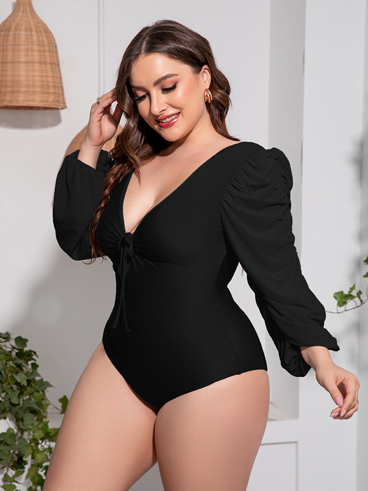 Black one-piece swimsuit with tie-front neckline and ruched balloon sleeves.