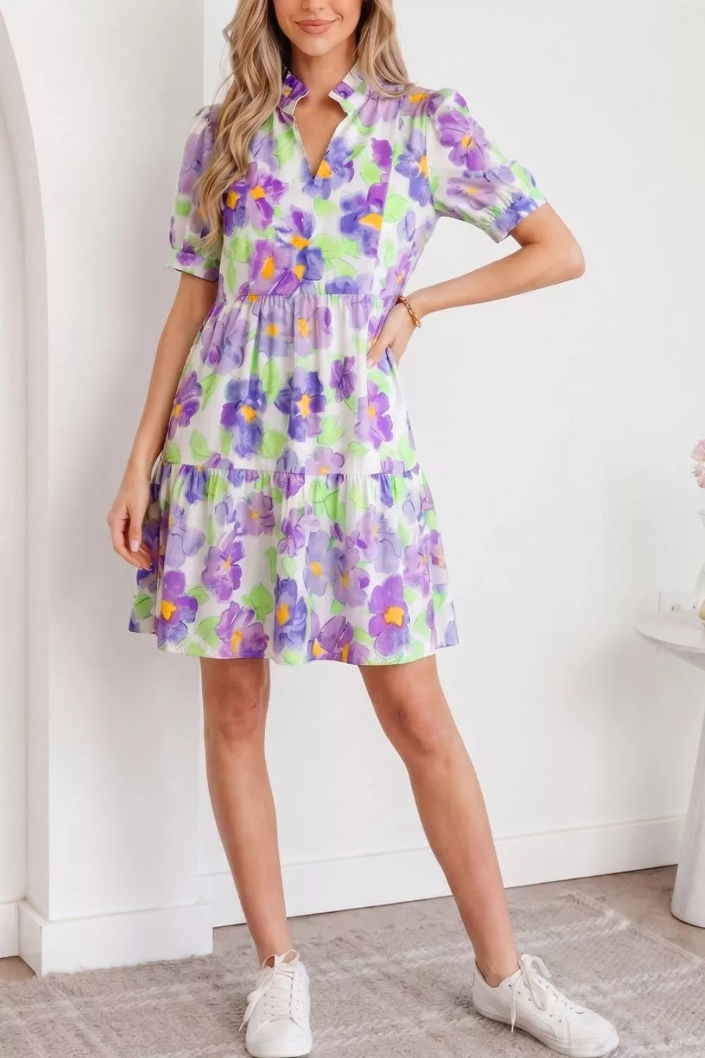Mini dress with vibrant floral print, tiered ruffles, short sleeves, and V-neck.