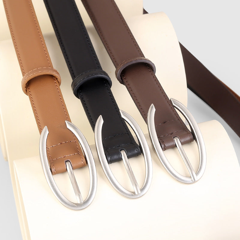 Leather belts in black, brown, and coffee brown with oval silver buckles.