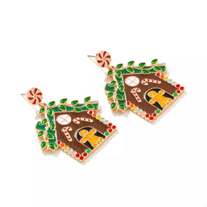 Festive gingerbread house dangle earrings with candy canes and gingerbread men, gold tone.