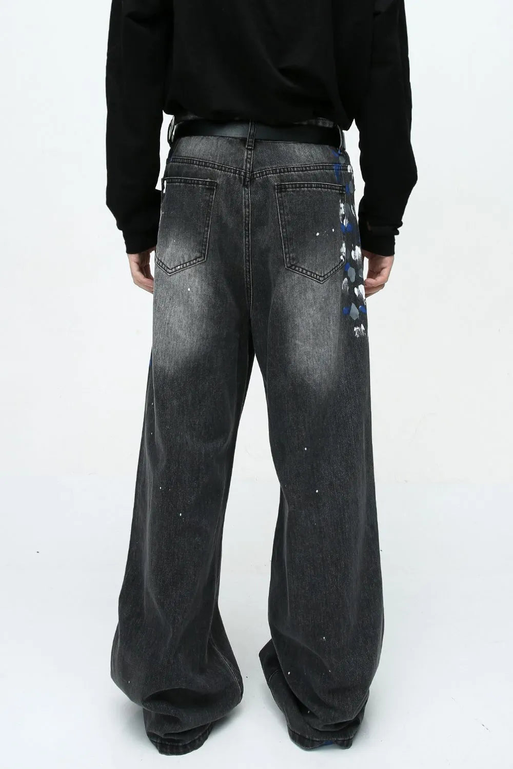 Dark wash wide leg jeans with painterly brushstroke detail and paint splatters.