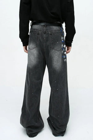 Dark wash wide leg jeans with painterly brushstroke detail and paint splatters.
