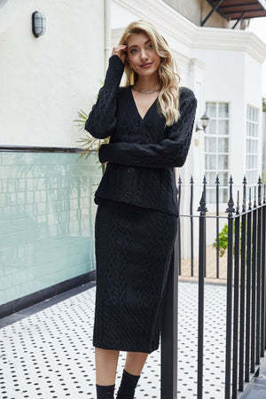 Black cable knit cardigan and pencil skirt set with V-neck and button front.