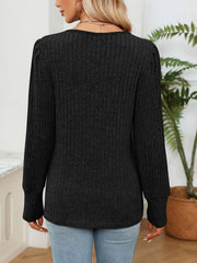 Black ribbed knit sweater with lace trim detail and long sleeves.