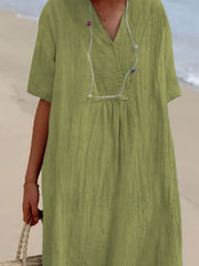 Light green V-neck casual midi dress with short sleeves and textured fabric.