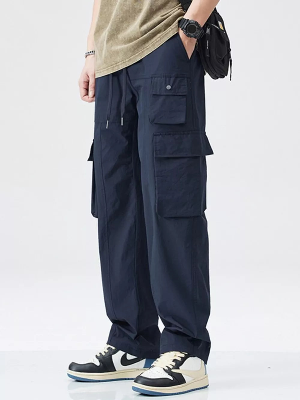Dark blue utility sweatpants with multiple cargo pockets and drawstring waist.