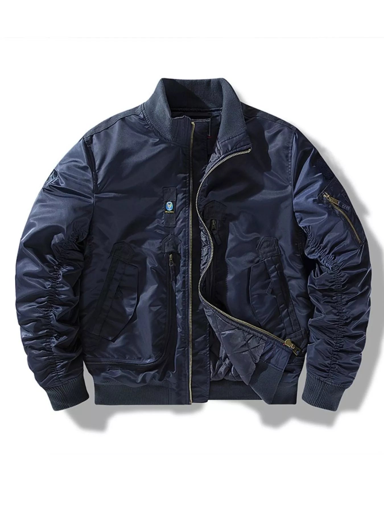 Navy zip-up bomber jacket with ruched sleeves and zippered pockets.