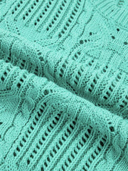 Pointelle knit sweater in mint green with cable and openwork details.