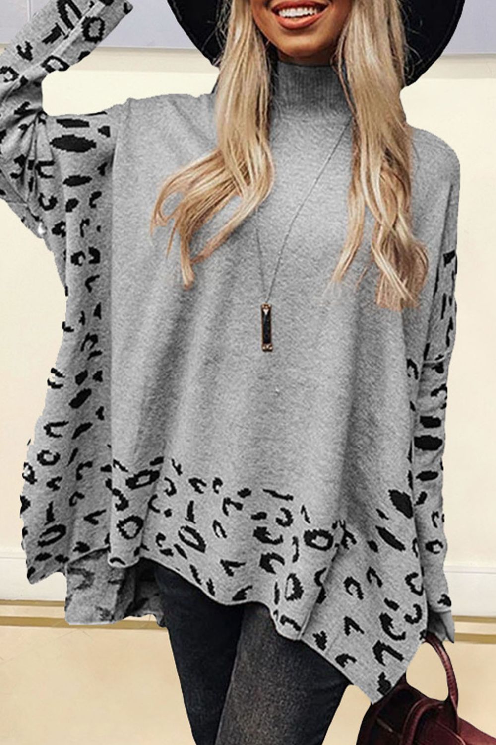 Gray turtleneck sweater with asymmetric leopard print panels and a high-low hem.