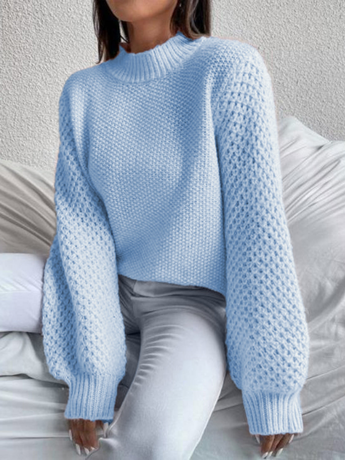 Pastel blue acrylic knit sweater with mock neck and textured puff sleeves.