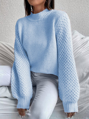 Pastel blue acrylic knit sweater with mock neck and textured puff sleeves.