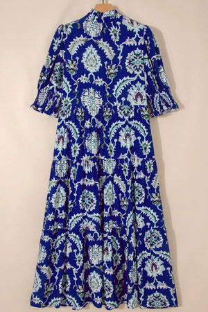 Maxi dress with blue floral print, frilled collar, tiered skirt, and puff sleeves.