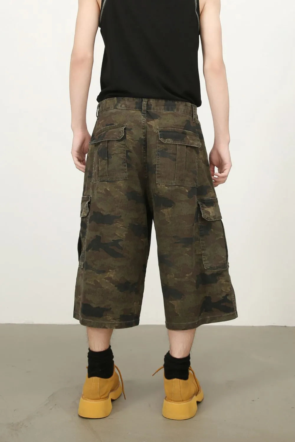 Camo culotte cargo shorts in green camouflage with multiple pockets.