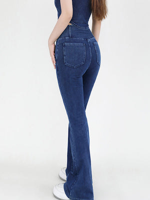 Crossover waist flare jeans in medium wash denim with a bootcut leg.