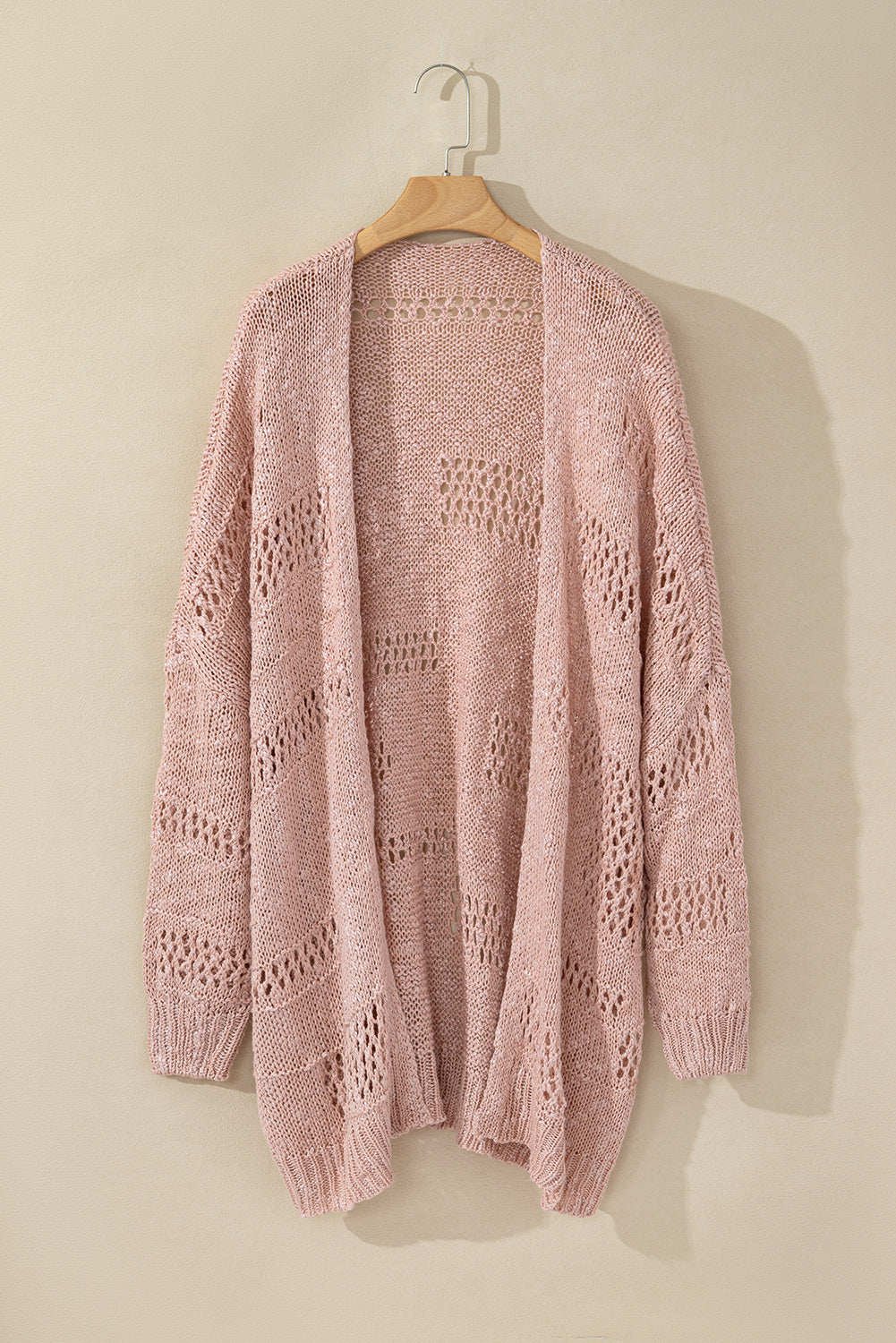 Dusty pink open-knit slouch cardigan with airy crochet details and ribbed cuffs.