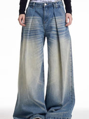 Men's wide leg blue washed denim jeans with a baggy fit and gradient fade.