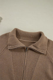 Taupe knit zip-through jacket with a collared neckline and ribbed details.