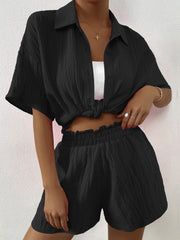 Black textured resort shirt and shorts set with button front and elastic waist shorts.
