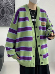 Oversized green striped V-neck cardigan with buttoned front and a small patch detail.