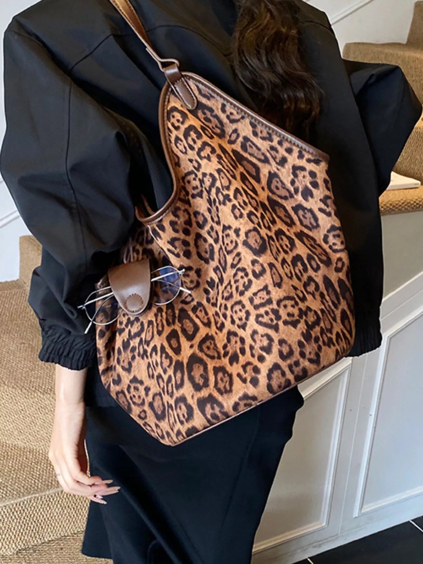 Chic leopard print tote bag with brown trim and a glasses holder detail.