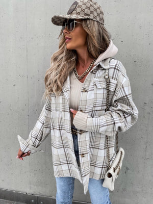 Oversized plaid shacket with attached hood in beige and white, featuring buttoned front and cuffs.