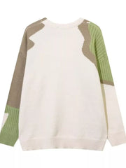 Men's cream sweater with abstract green and tan color block details and textured sleeves.
