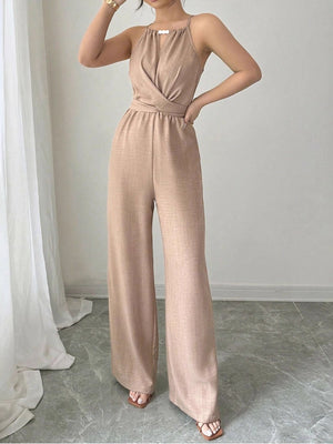 Beige halter neck wide leg jumpsuit with a crossover bodice and drawstring waist.