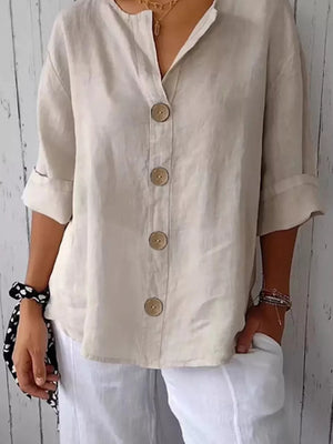 Beige button-down shirt with relaxed fit, collarless neckline, and natural wood buttons.